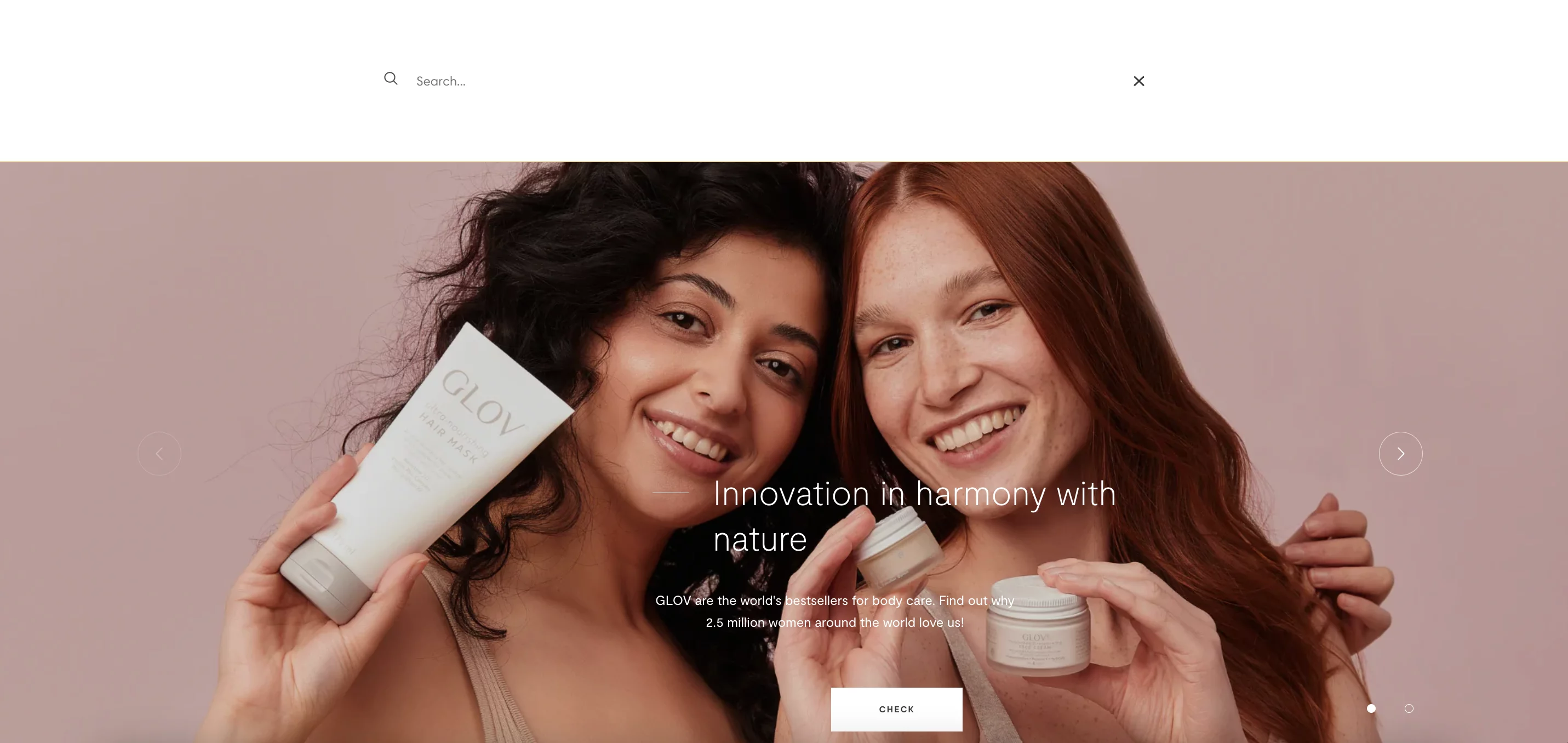 Two smiling women holding GLOV skincare products against a soft pink background.
