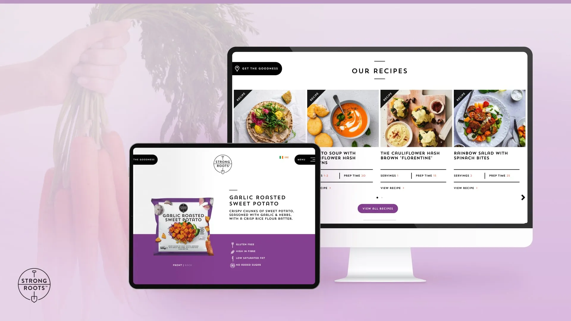 Digital devices showing Strong Roots product Garlic Roasted Sweet Potato and a recipe webpage with various vegetable dishes on a purple background with a hand holding fresh carrots.