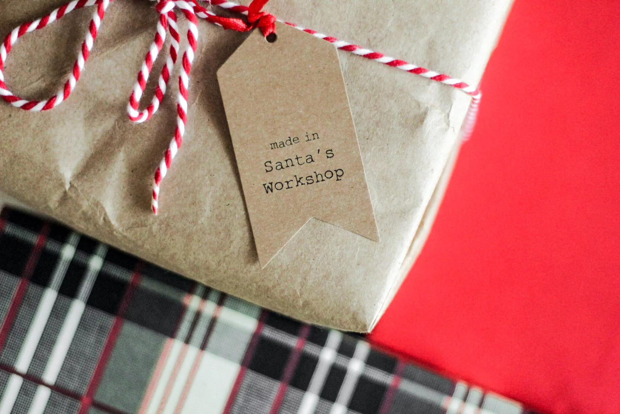 Kraft-paper gift tied with red and white twine and a 'made in Santa's Workshop' tag, for holiday e-commerce strategy