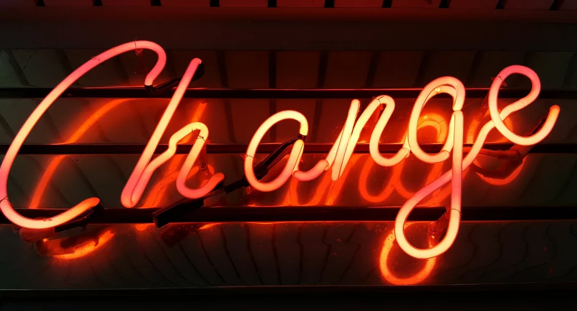 Orange neon sign spelling 'Change' in script letters, symbolising new Shopify developments in 2021 and 2022