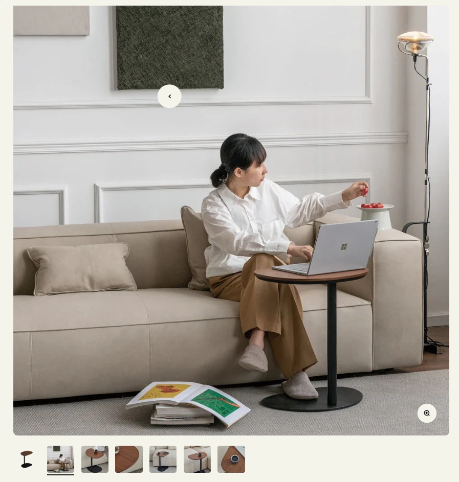 Grado Design product gallery showing a walnut side table next to a beige sofa in a lived-in room, with angle and close-up thumbnails