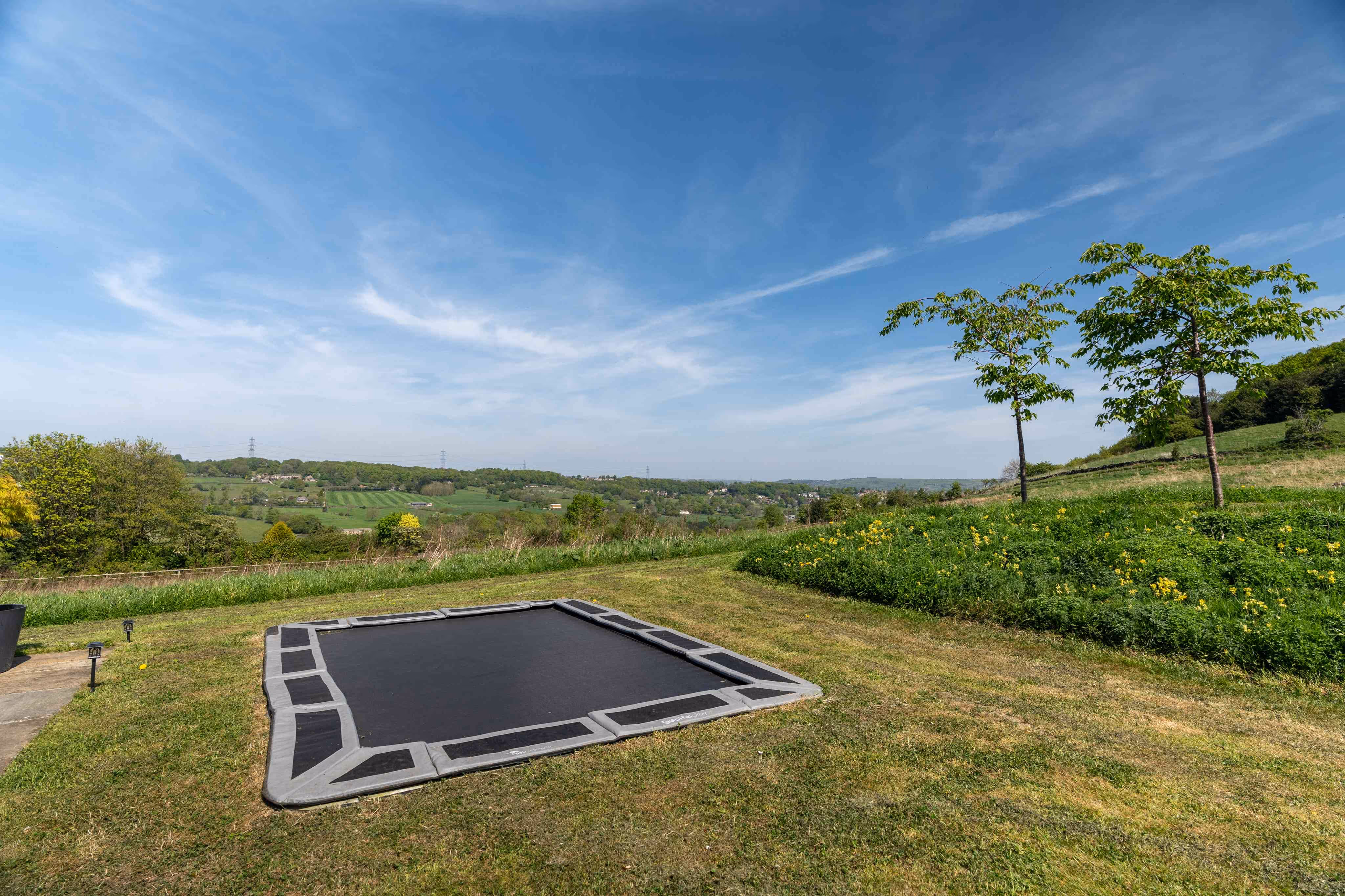 A sunken trampoline surrounded by the green Yorkshire country side