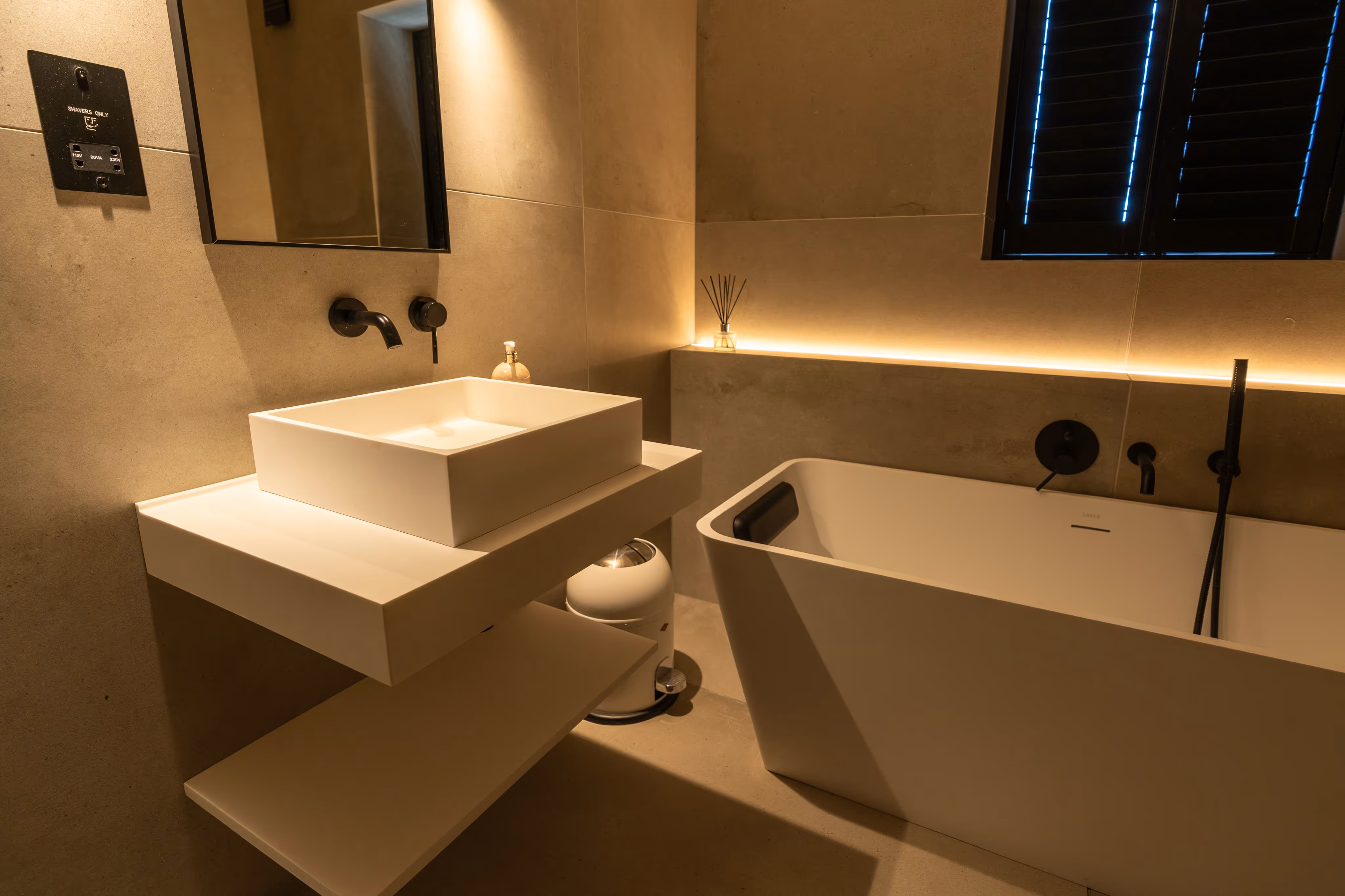 The annex bathroom shows a freestanding bath, with mood lighting to the side off it
