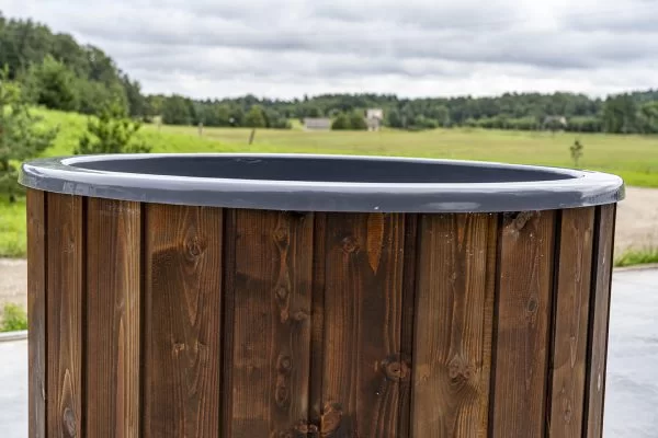 An Image of a a ice bath looking out onto a open field.