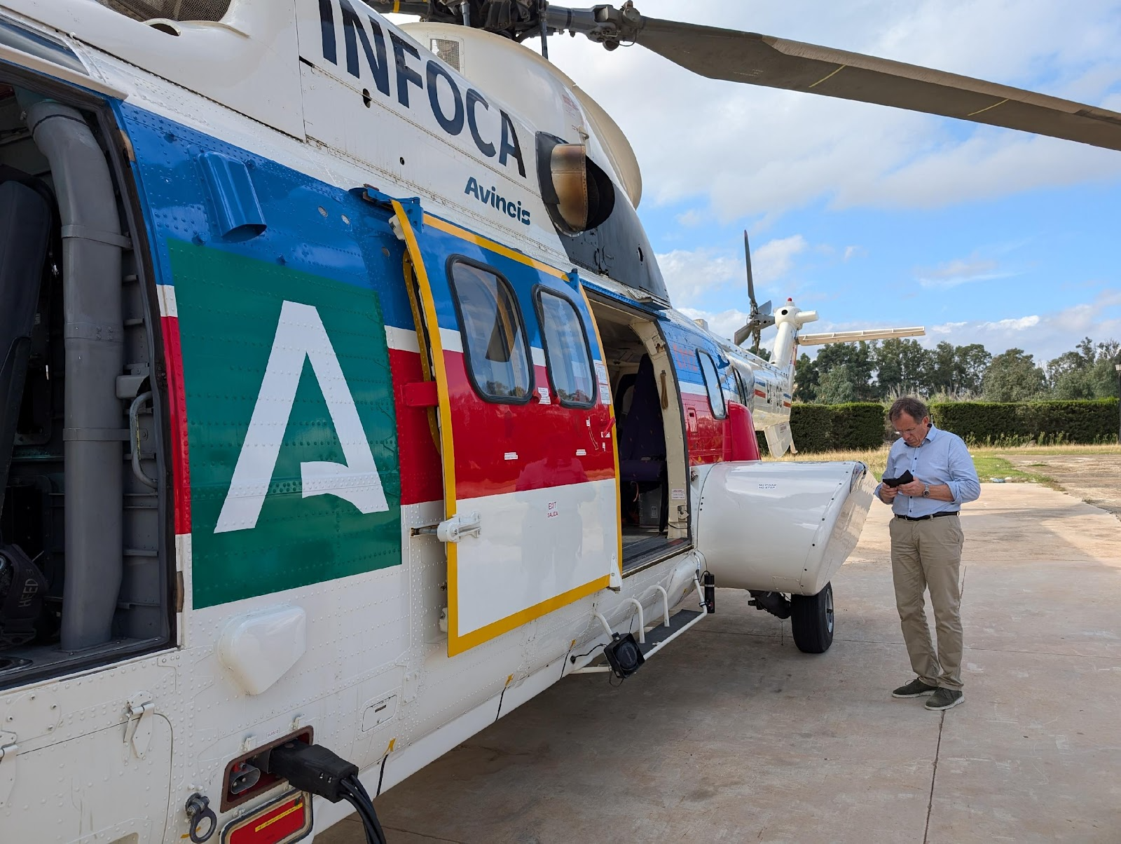 A person standing next to a helicopterAI-generated content may be incorrect.