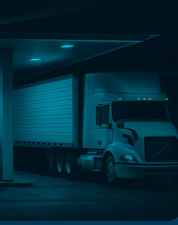 Large truck parked under canopy.