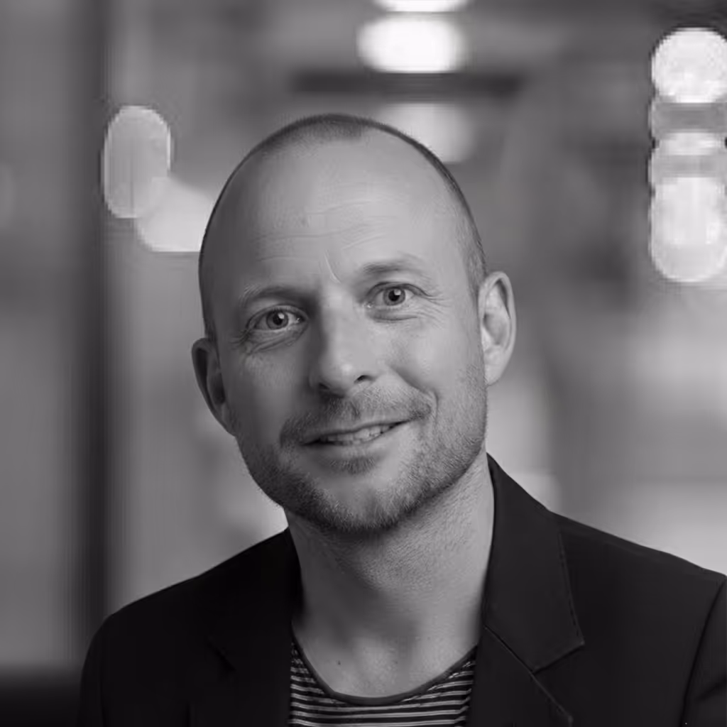 Headshot of Tom Hughes, one of the founding partners