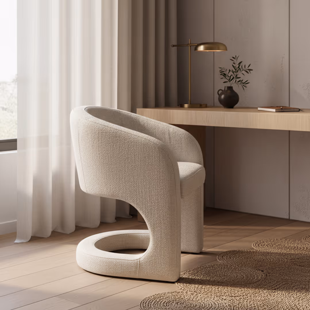 Minimalist guest bedroom interior with 1902 Orvietto fully upholstered desk chair, light wood desk, gold lamp, and sheer curtains