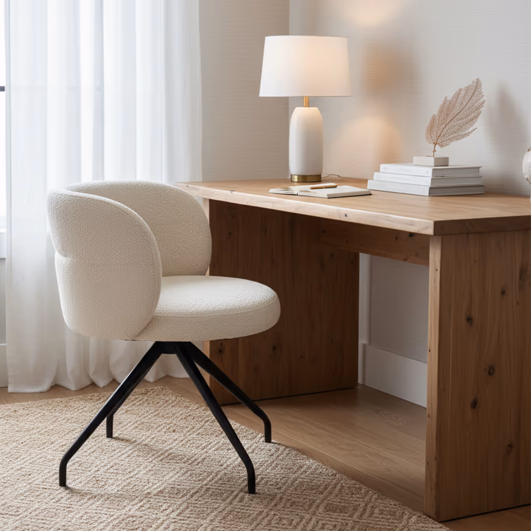 Contemporary hotel guest room white 1902 Asti swivel desk chair, wood desk, gold-accented lamp, and natural light through sheer curtains