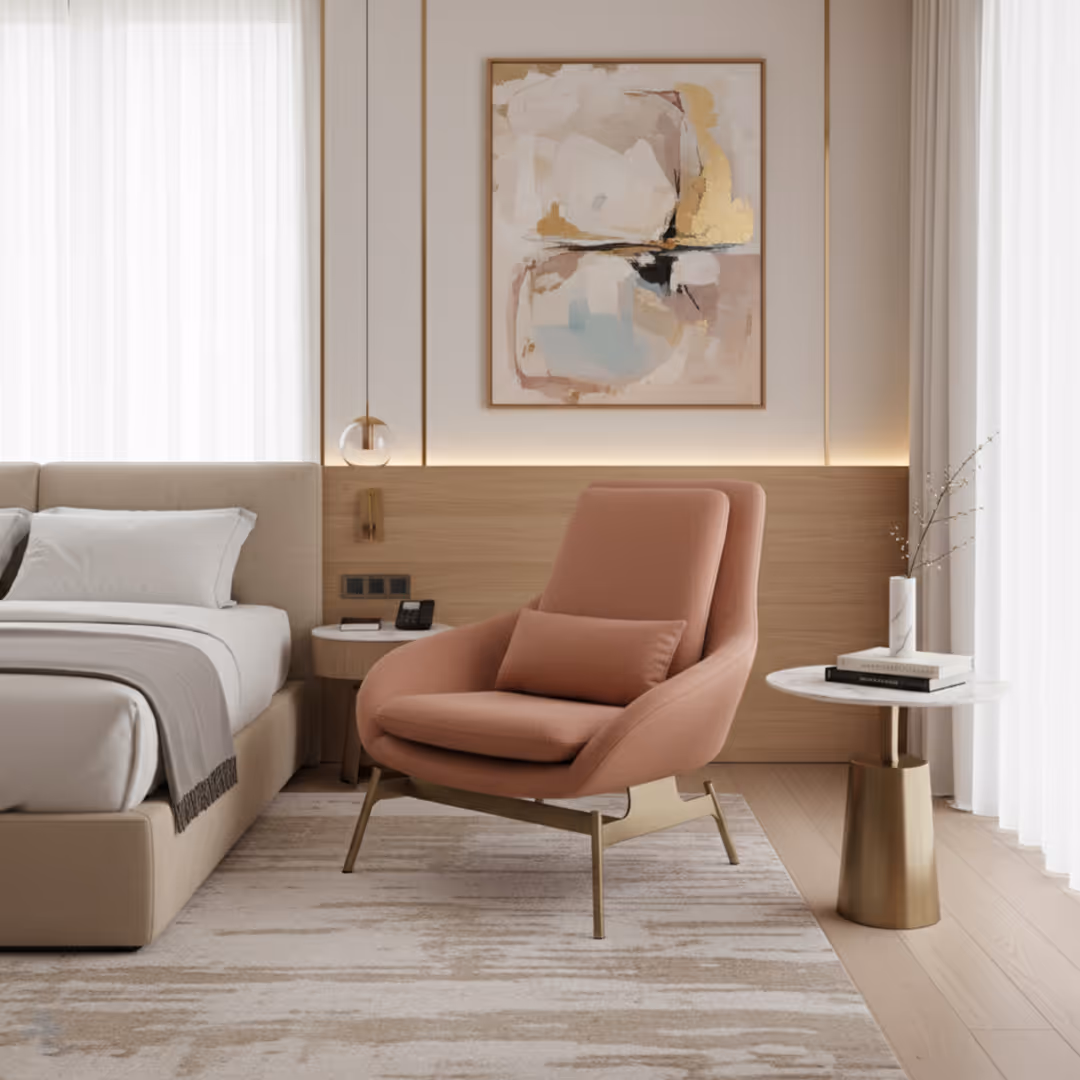 Hotel guestroom with beige bed, 1902 Blush accent chair in pink, marble side table, and pastel abstract artwork