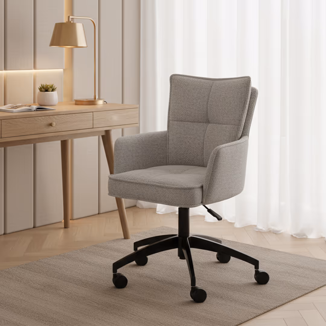 Contemporary hotel guestroom with light grey 1902 Maestro desk chair, wood desk, gold lamp, and natural light through sheer curtains