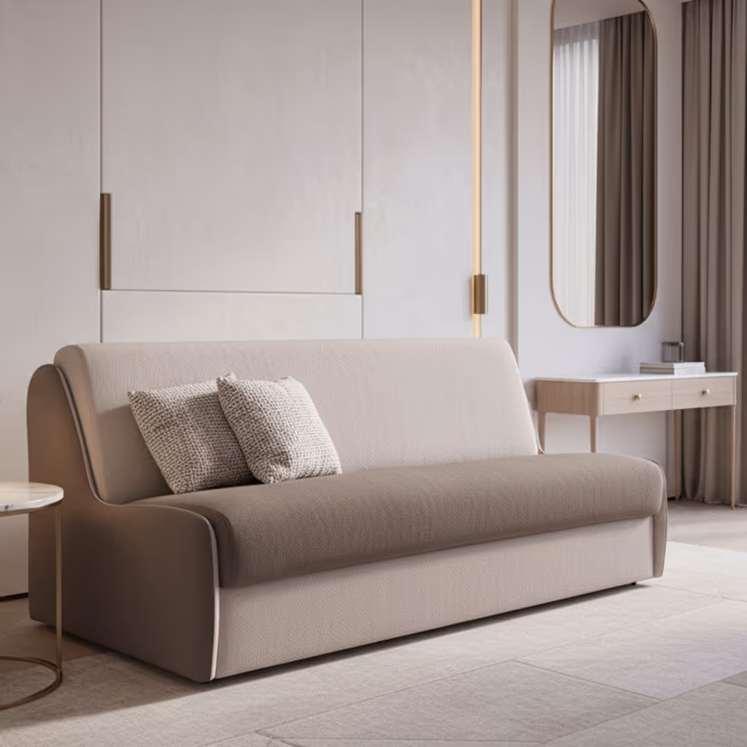 Luxury hotel suite with 1902 Sax beige sofa bed, brass-accented wall panels, console mirror, and soft taupe curtains