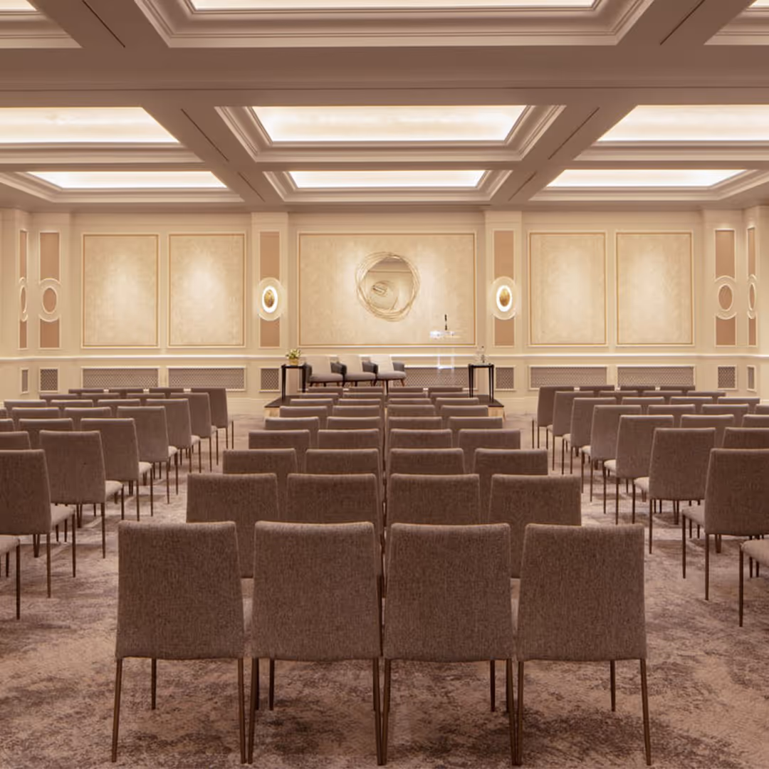 Elegant hotel conference room with 1902 Iver upholstered stacking chairs, coffered ceiling, ambient lighting, and symmetrical stage setup