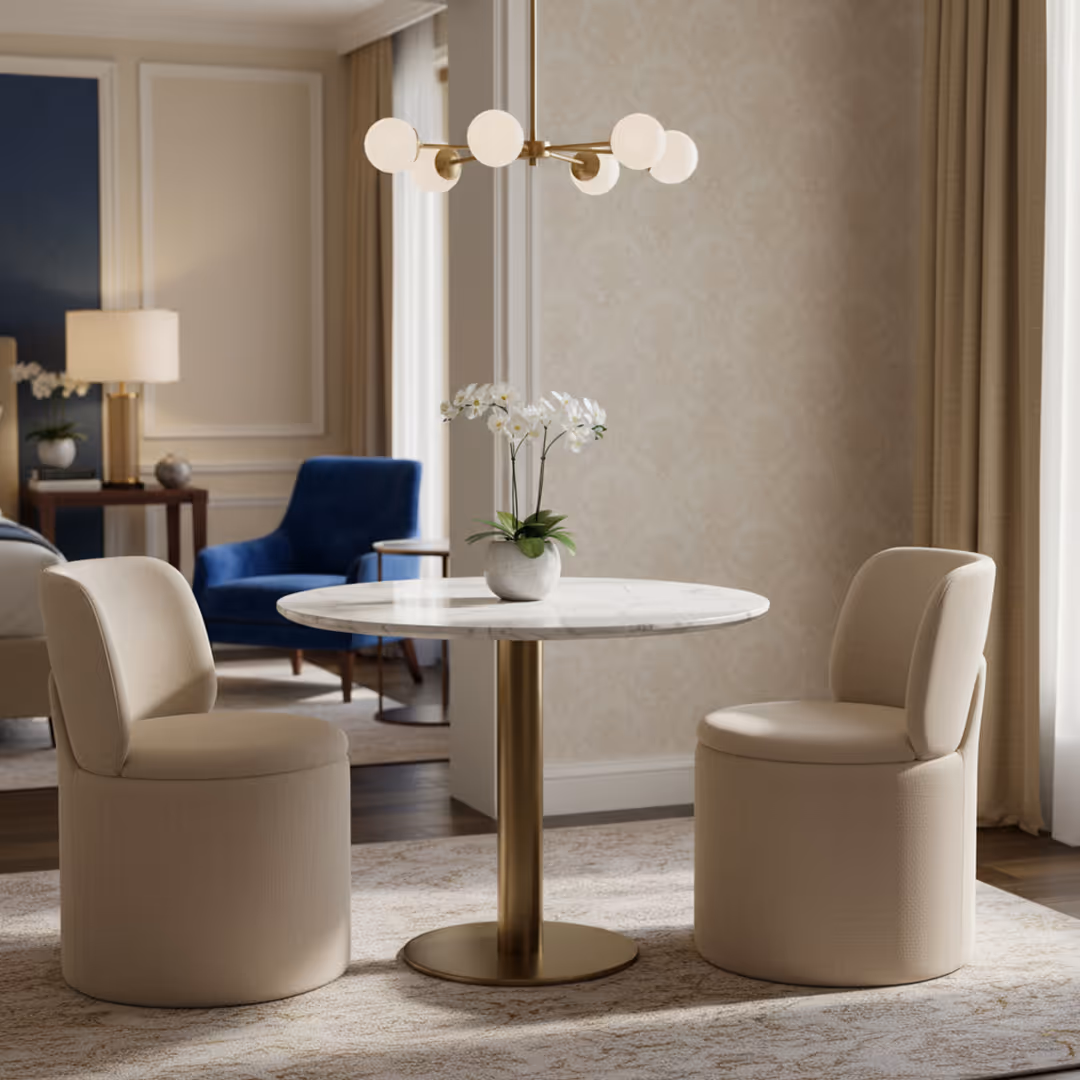 Hotel suite with 1902 Mensa table, 1902 beige Chloe upholstered chairs, and gold chandelier beneath patterned wallpaper and floor-length curtains