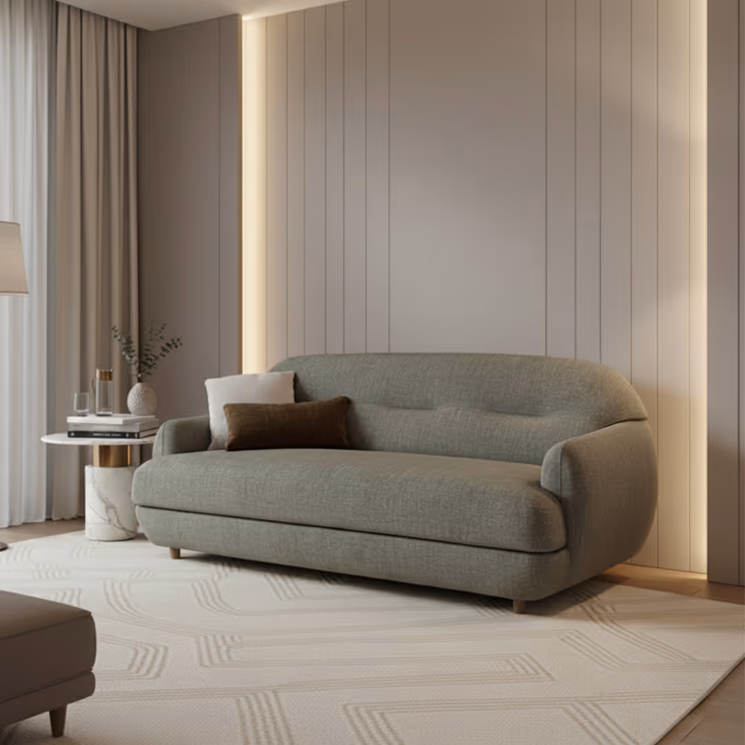 5* hotel guestroom room with 1902 Plum sofa in green fabric, ambient wall lighting, marble side table, and geometric rug