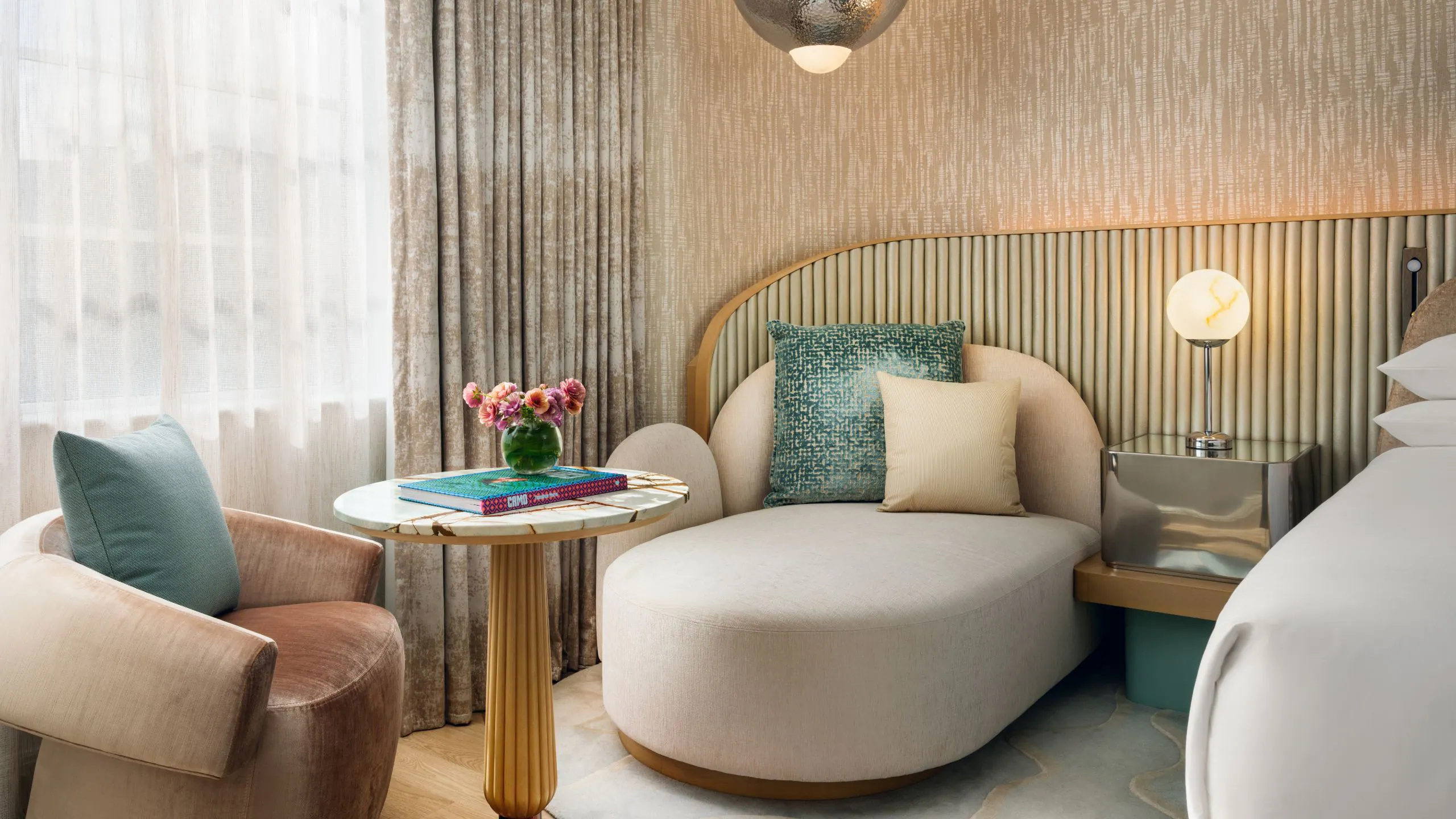 Bright, contemporary guestroom at Andaz with warm wood finishes, soft neutral tones, and an inviting lounge area.