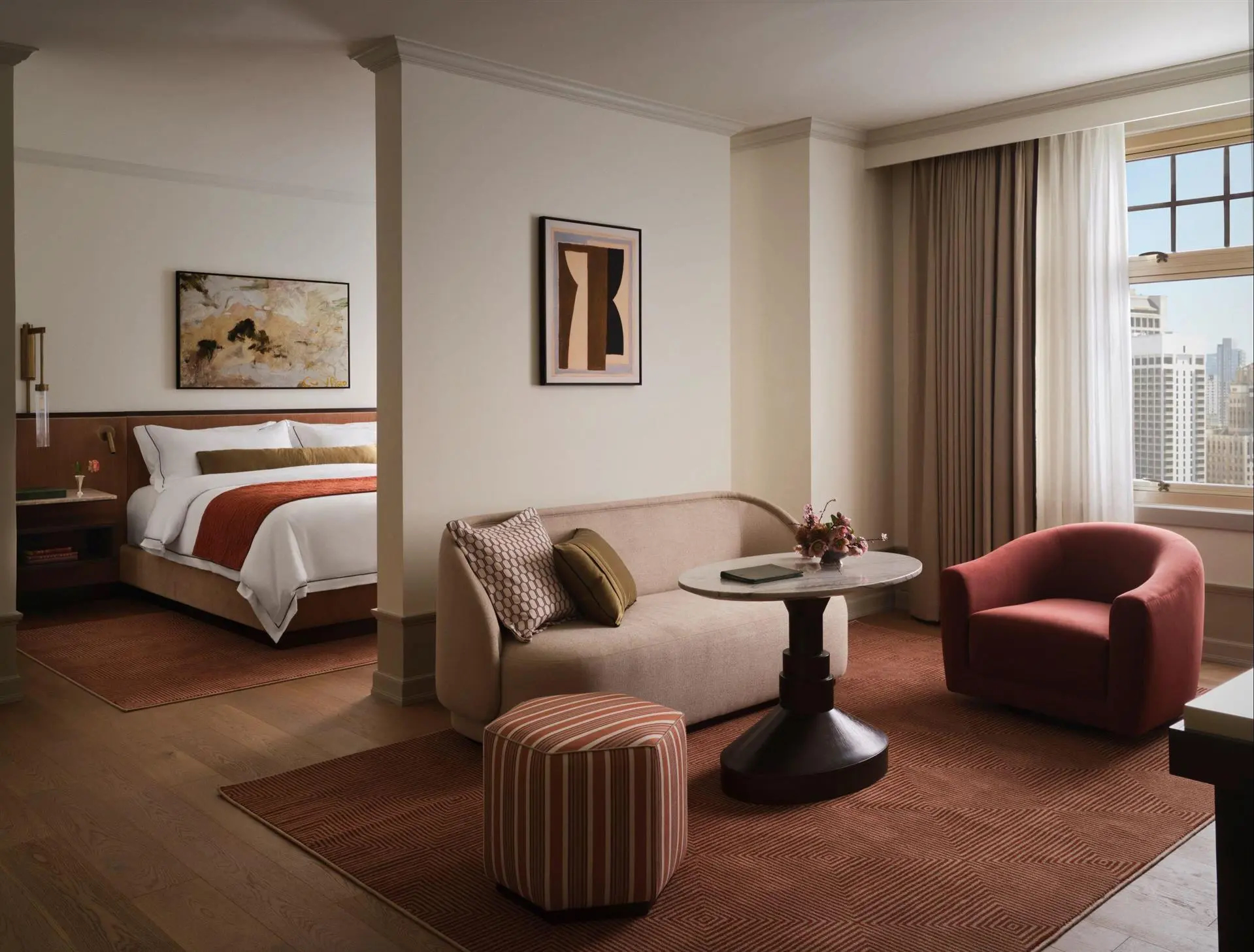 Stylish city suite with sculpted seating, warm wood accents, and refined furniture in rich earthy hues.