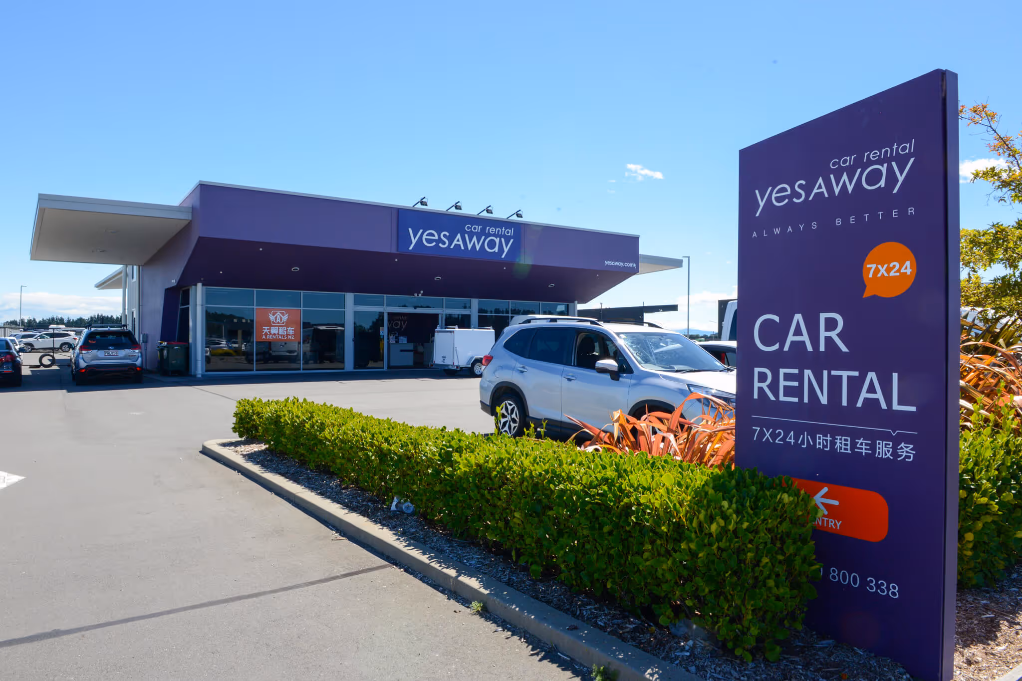 Outside of Yesaway Car Rentals building with sign in foreground