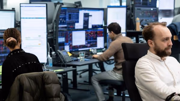 A man sitting in front of a computer monitor.