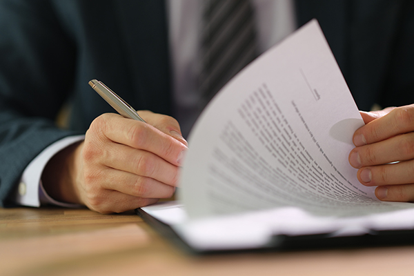 A man signing a contract