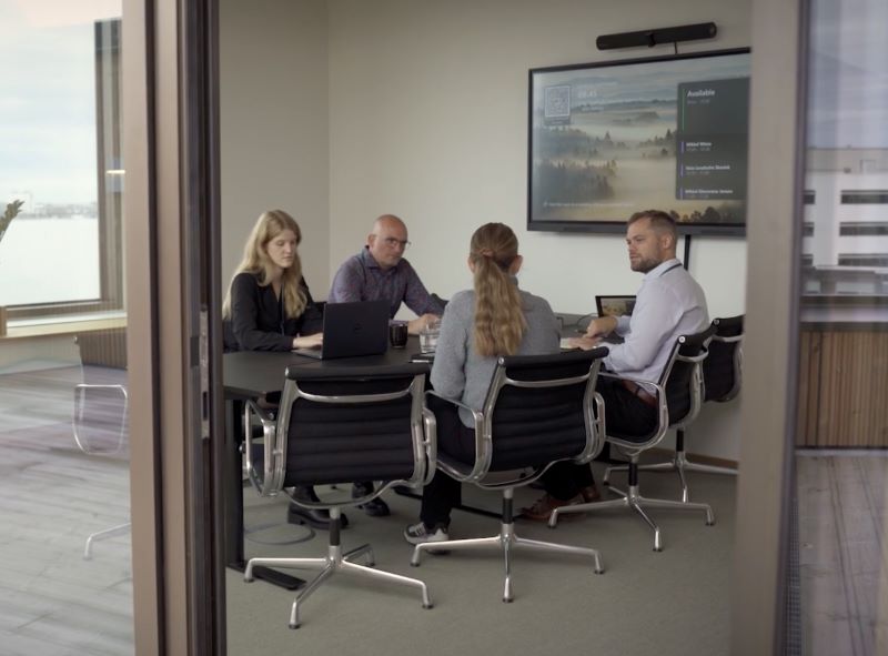 A group of people sitting around a conference table.