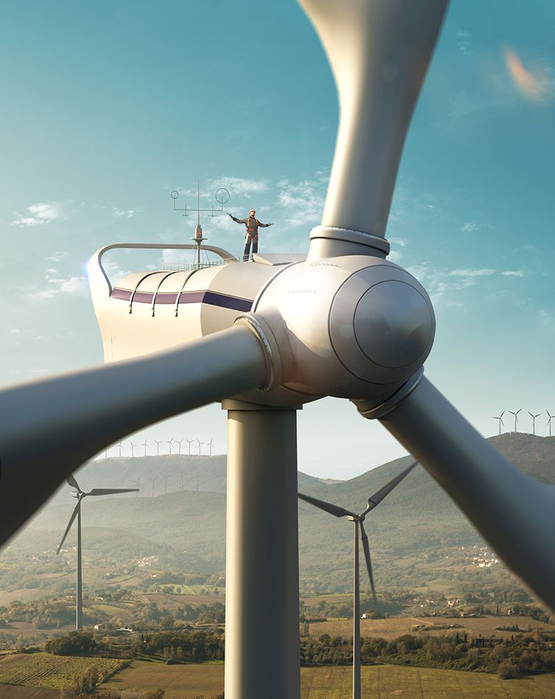 A man standing on top of a wind turbine.