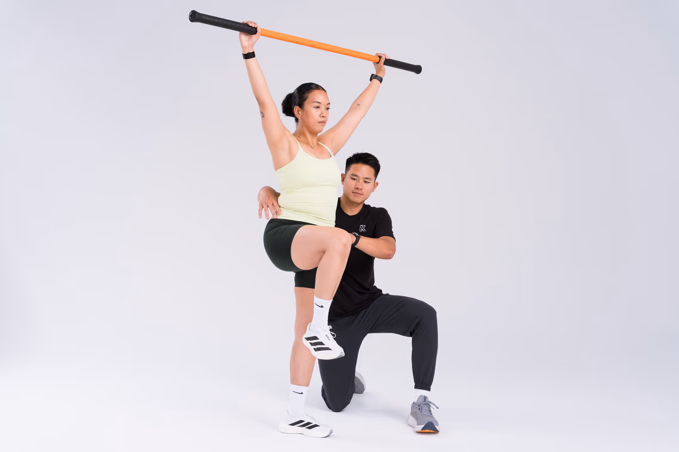 Overhead march with stick with pelvic cuing