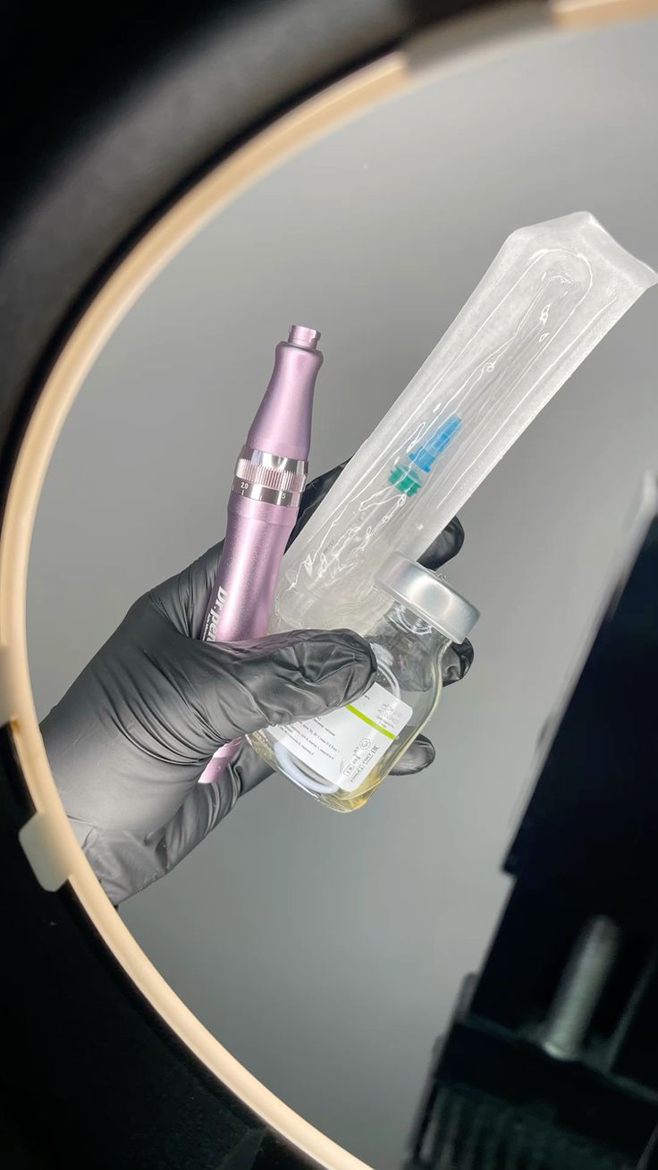 Aesthetic medical device and sterile syringe held by gloved hand