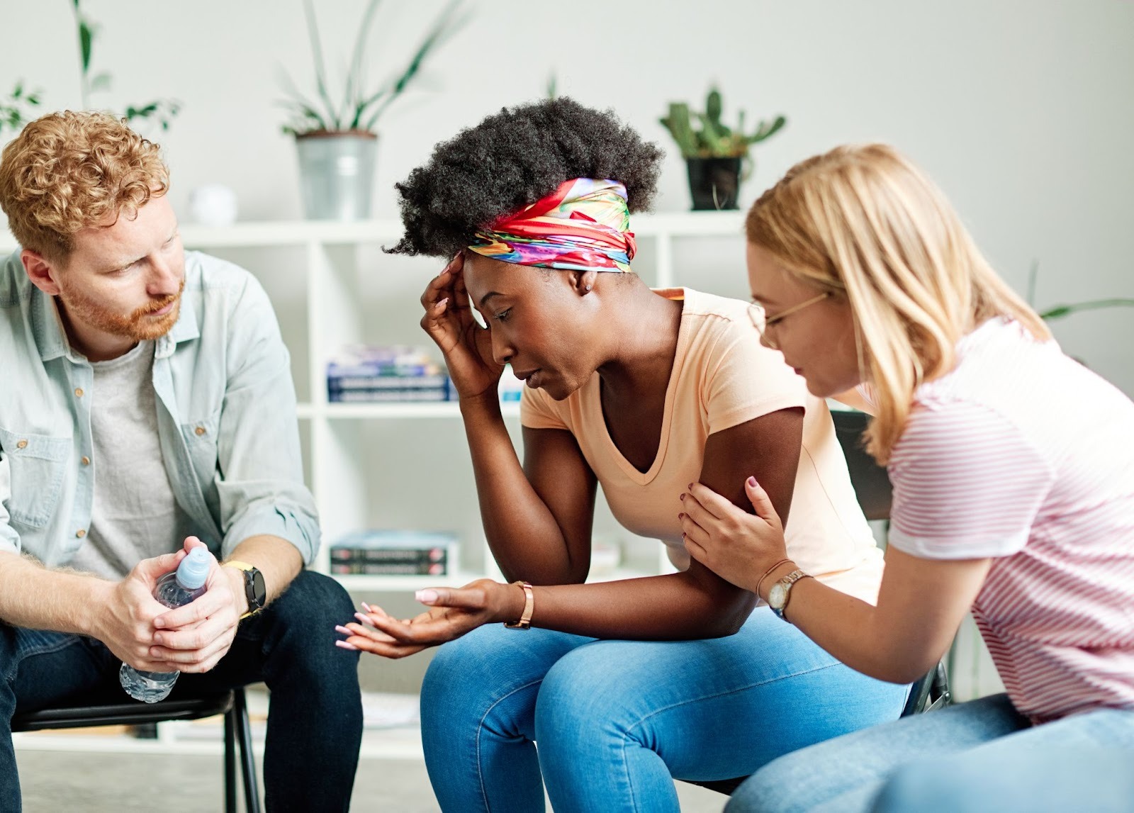 Peer support discussion helping an employee manage workplace stress as part of behavioral health risk management