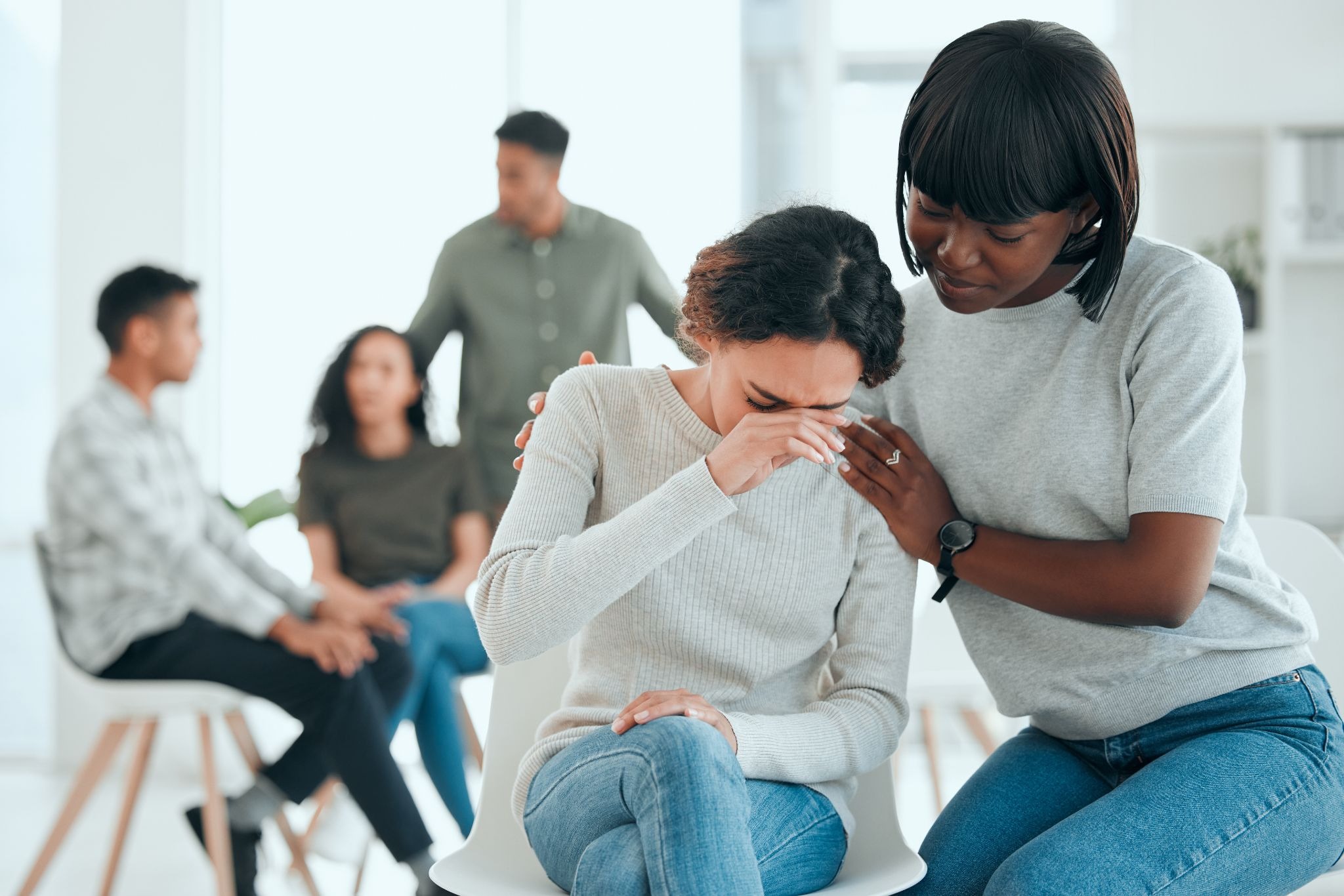Woman receiving emotional support while dealing with workplace stress and micro-trauma symptoms