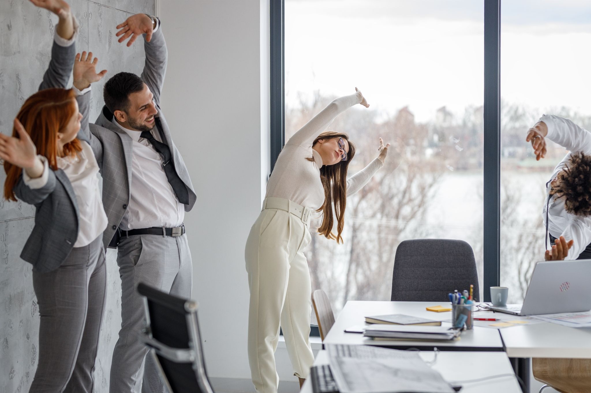 Employees doing office wellness exercises