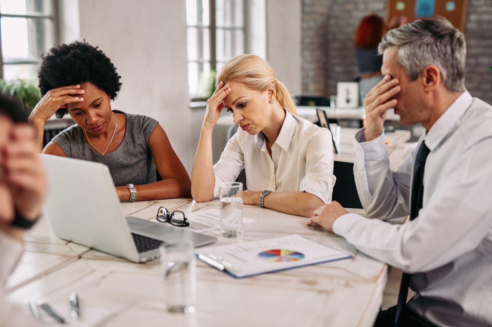 Employees showing workplace stress during a mental health assessment meeting