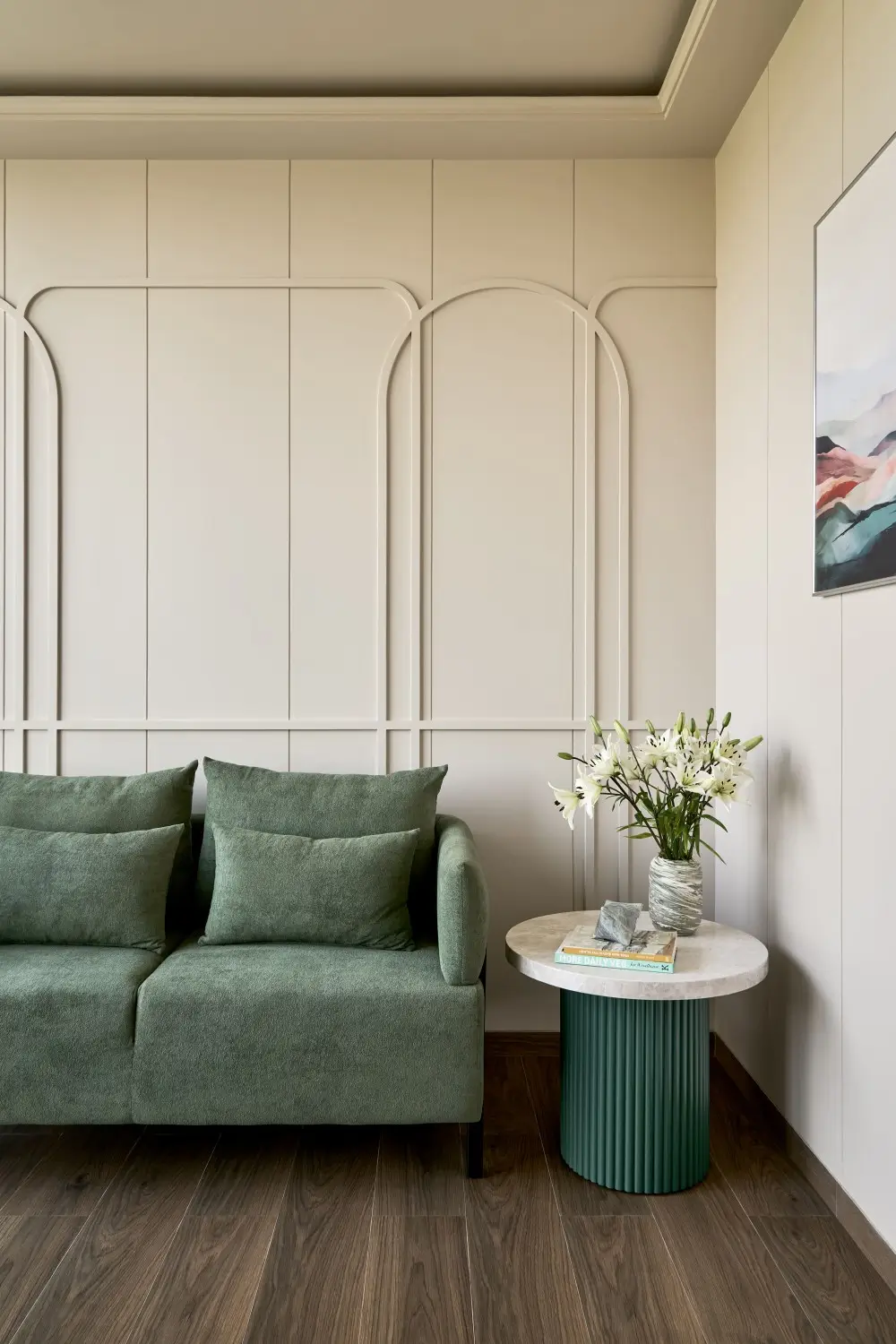 Sofa with green cushions and decorative wall paneling