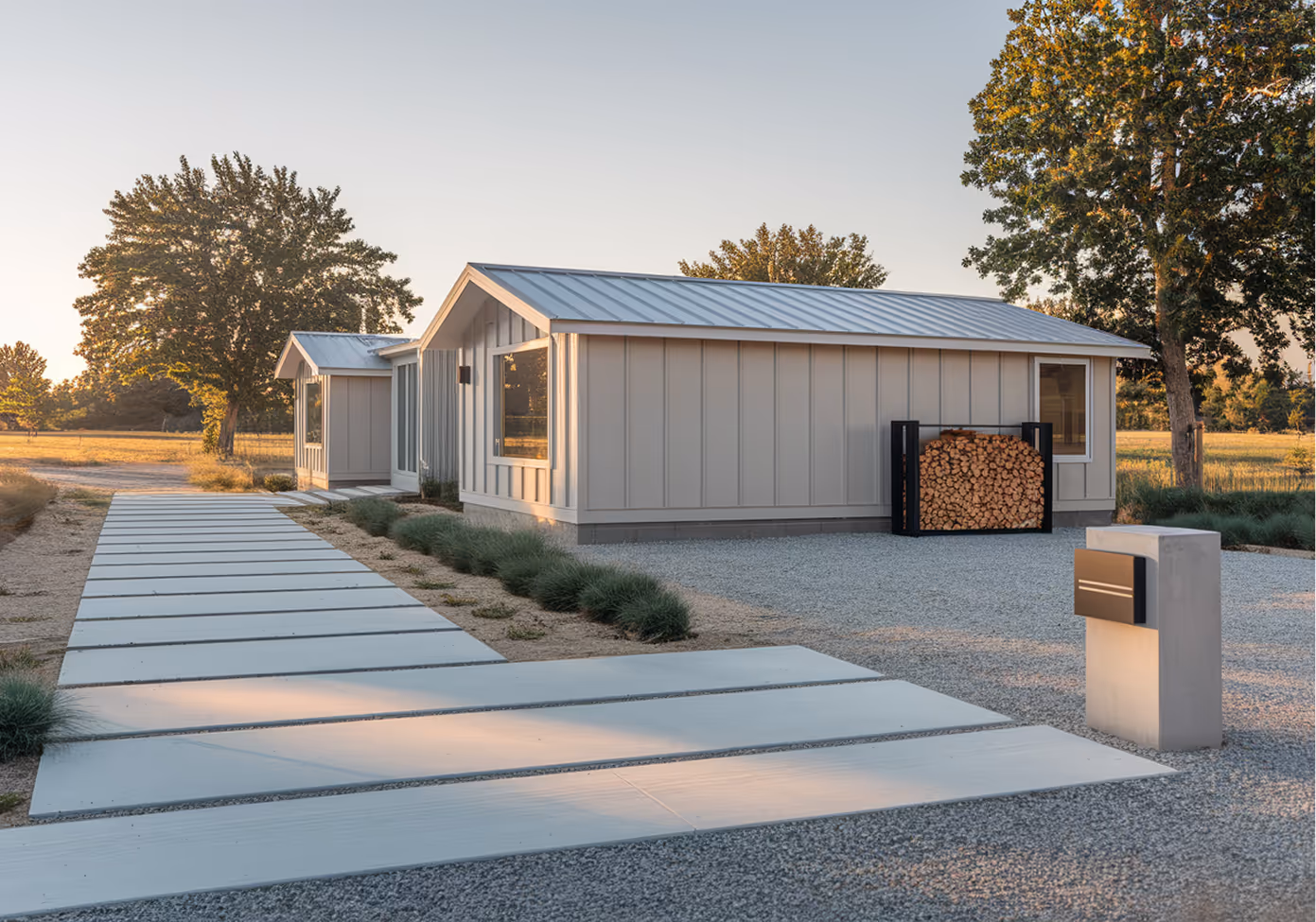 Two modular homes next to each other with a modern driveway leading up to them.