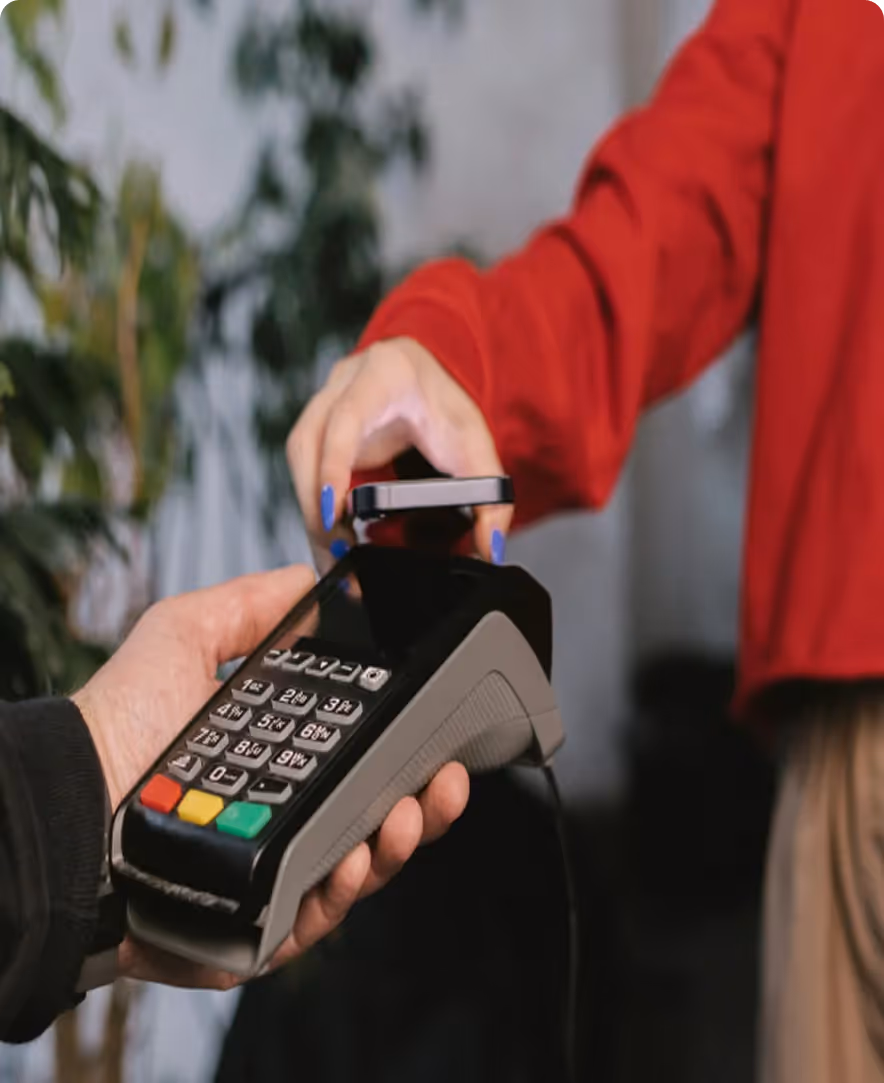 a man places his bank card on an EFTPOS terminal to make a payment