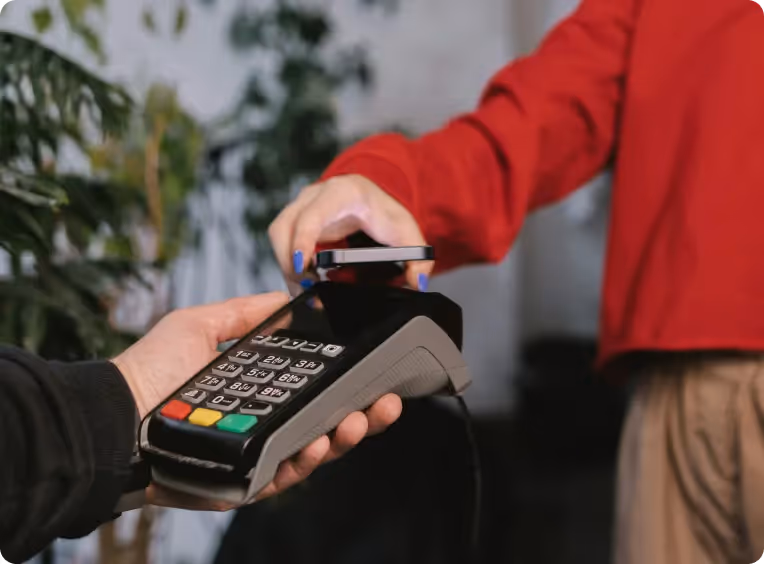 a man places his bank card on an EFTPOS terminal to make a payment