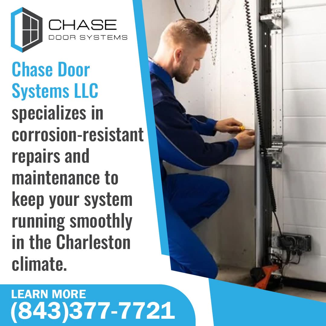 Technician repairing commercial garage door system components.