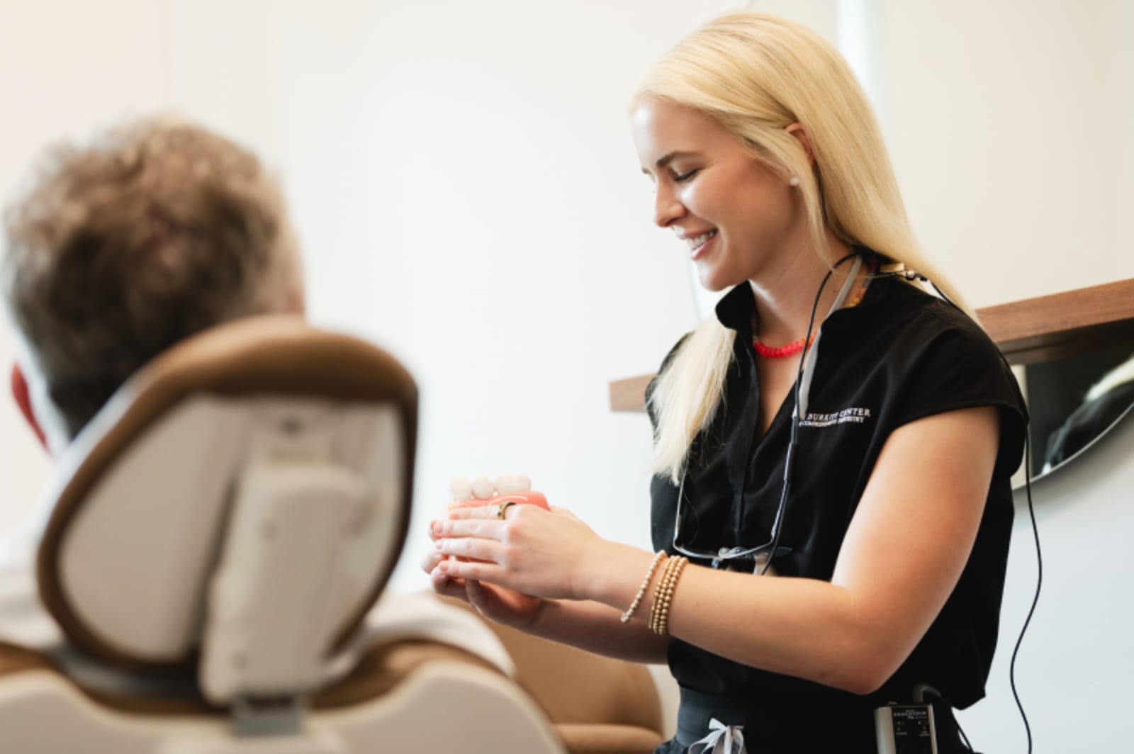 Dentist discussing treatment with patient during consultation at office