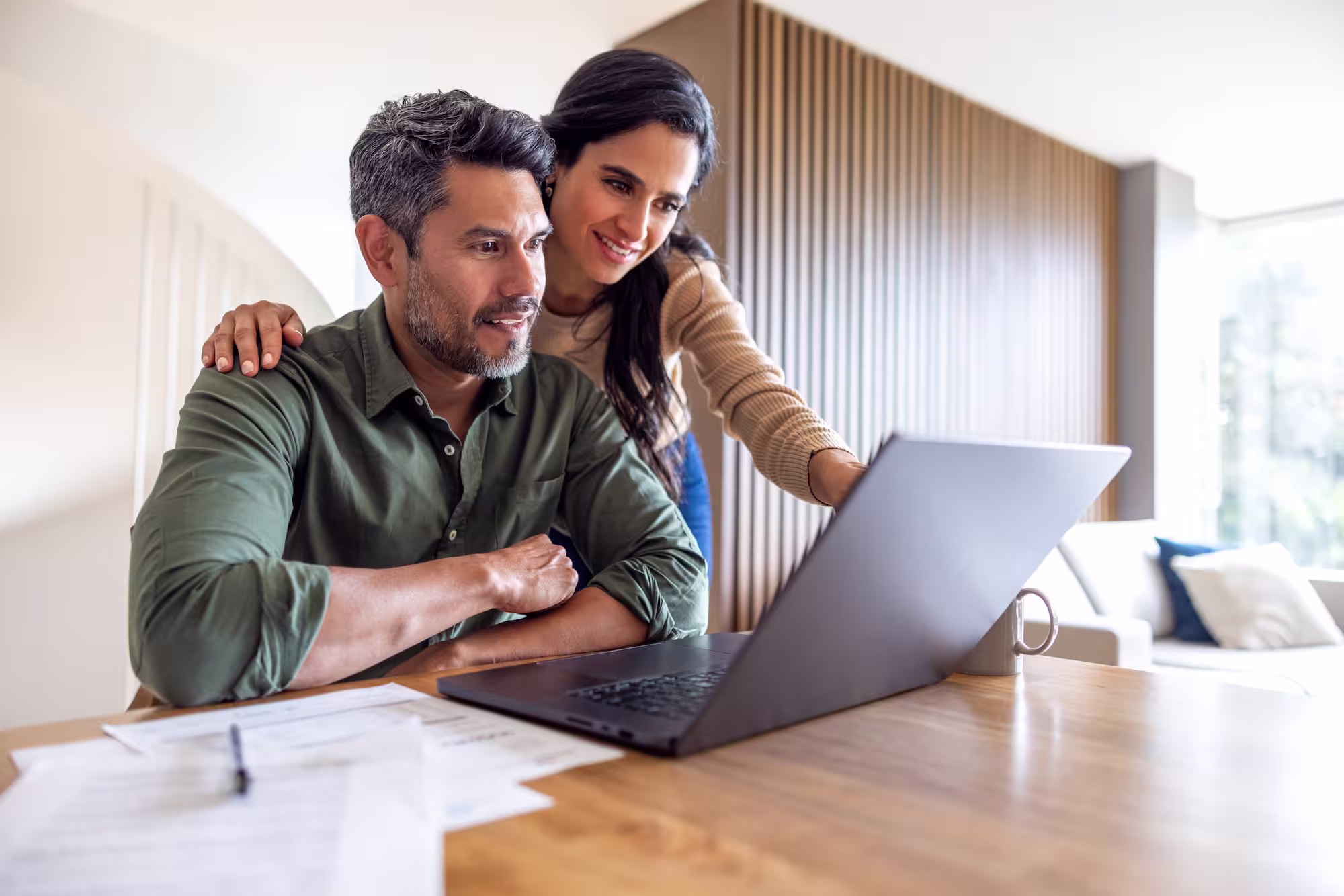 Couple looking at a laptop.