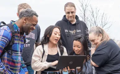 Group of people looking at laptop