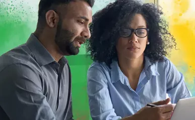 two people collaborating on tablet