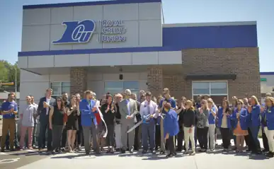 group of people cutting a ribbon to open a new Royal Credit Union location