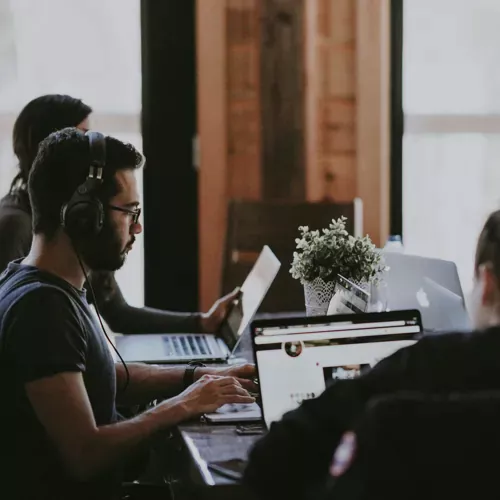 three people working on laptops