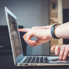 hand pointing on computer screen
