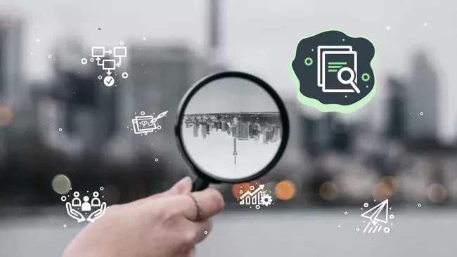 magnifying glass held up in front of city skyline