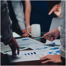 people collaborating around papers with data