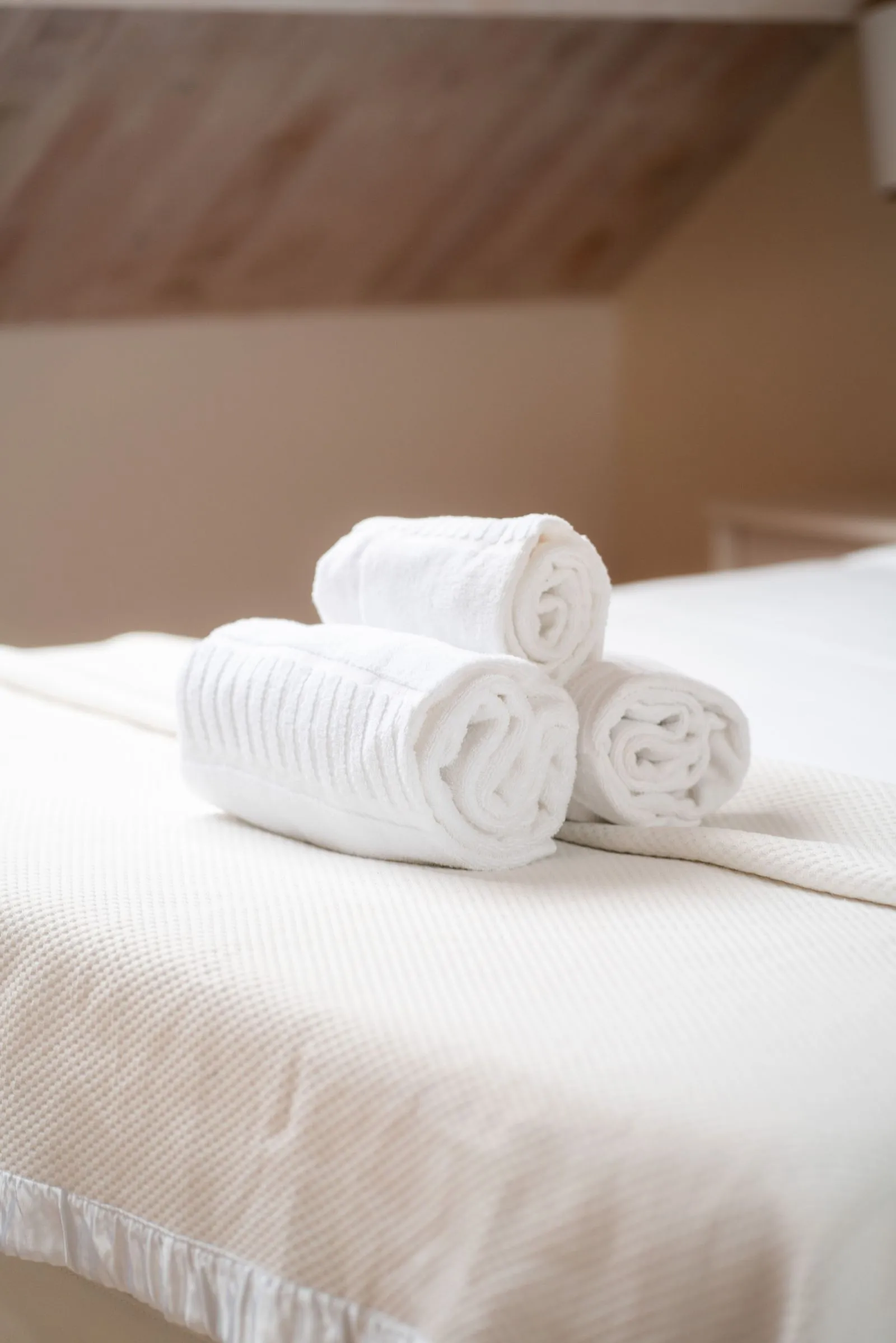 Cleaned towels in a bed.