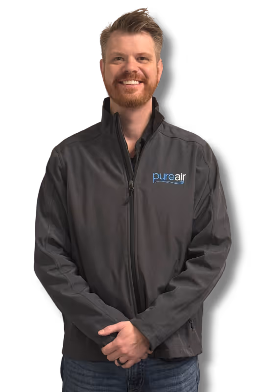 A Pure Air Pros employee, wearing a Pure Air Pros polo tee.