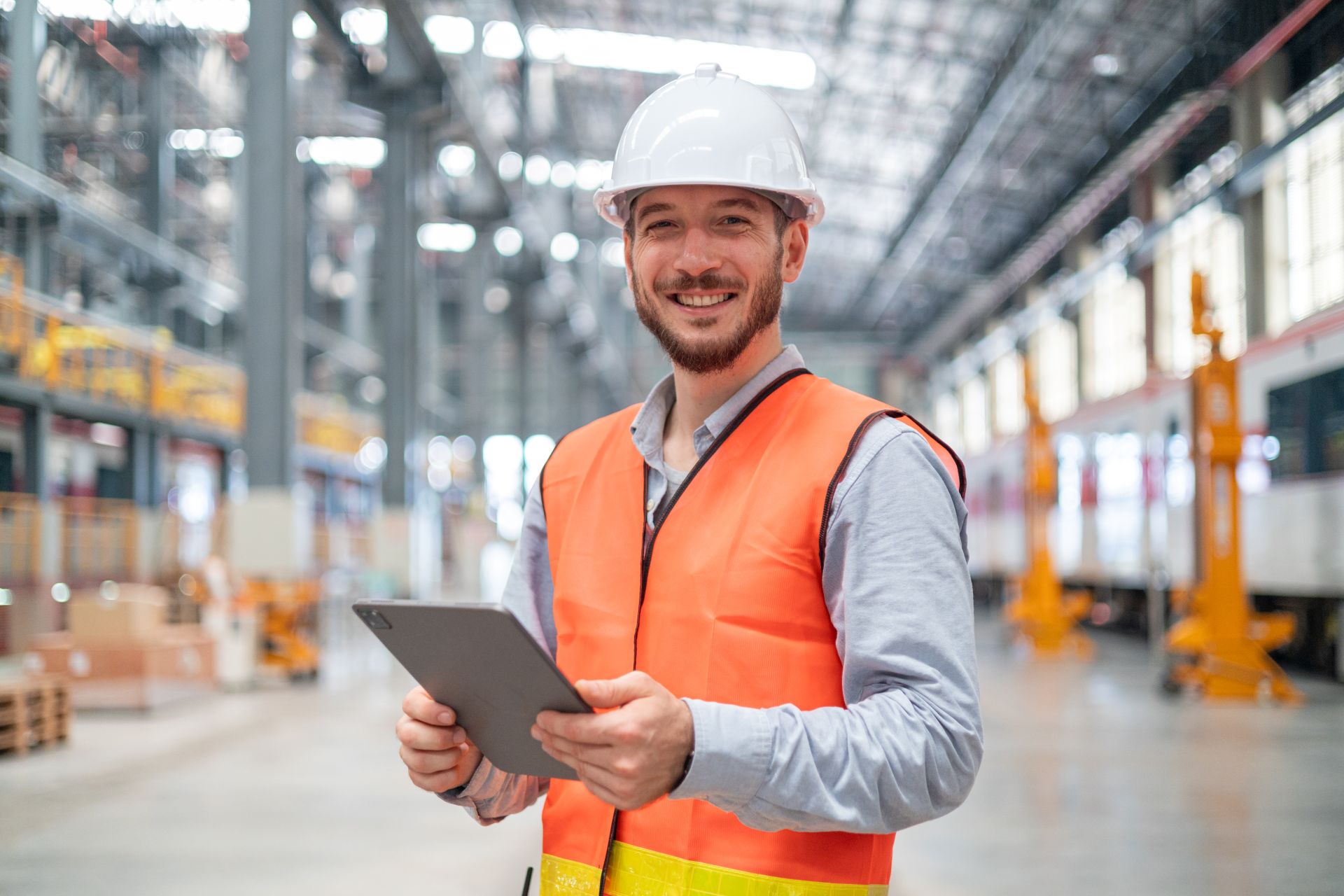 Happy contractor in uniform holding clipboard