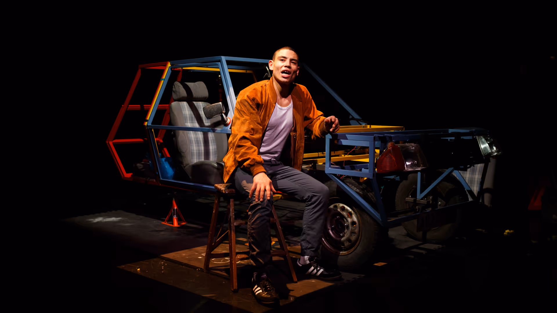 Photo of a performer on stage at a live theater show at Box of Tricks 